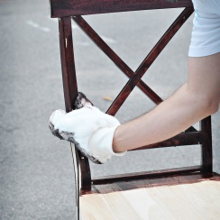 staining a chair with painter's mitt