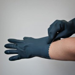 putting on black chemical gloves
